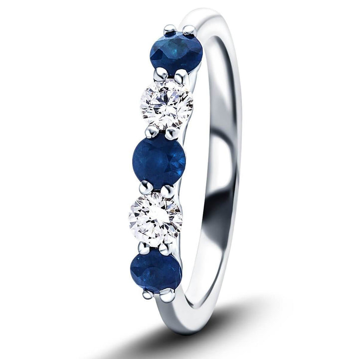 Anillo de cinco piedras con diamantes de 0,12 ct y zafiro azul de 0,25 ct en oro blanco de 18 k
