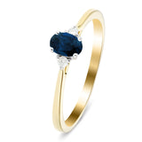 Zafiro azul 0.60ct Diamante 0.06ct Anillo de tres piedras Oro amarillo 9k