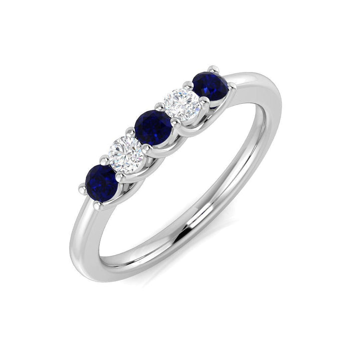 Anillo de cinco piedras con diamantes de 0,12 ct y zafiro azul de 0,25 ct en oro blanco de 18 k