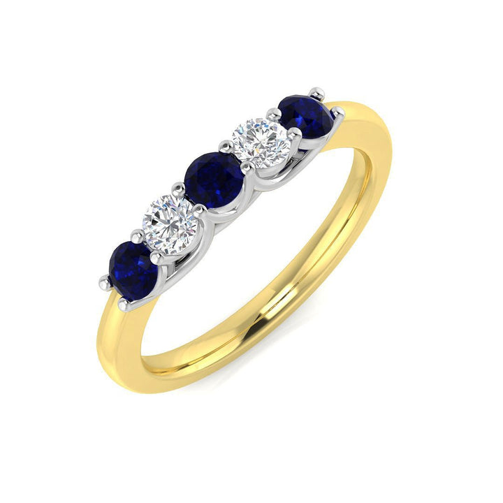 Anillo de cinco piedras con diamantes de 0,20 ct y zafiro azul de 0,35 ct en oro amarillo de 18 quilates