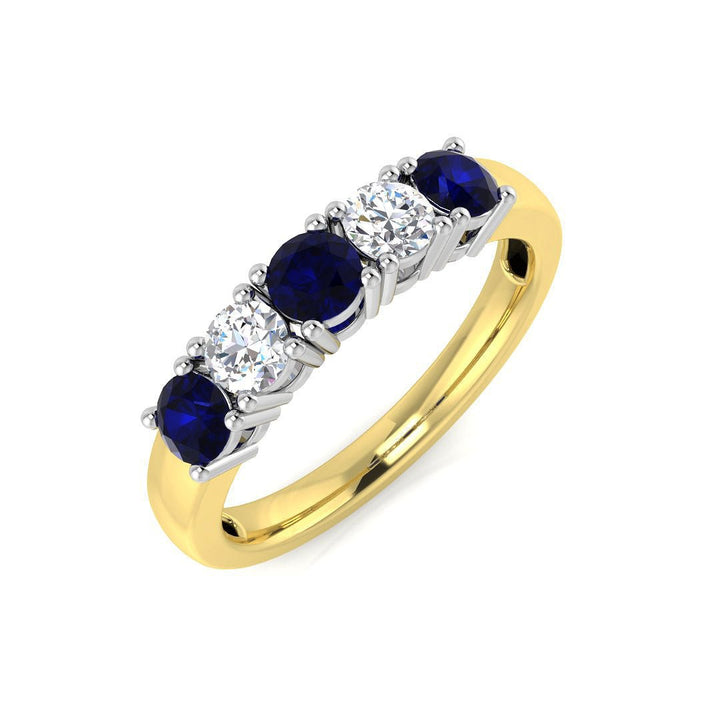 Anillo de cinco piedras con diamantes de 0,30 ct y zafiro azul de 0,60 ct en oro amarillo de 18 quilates