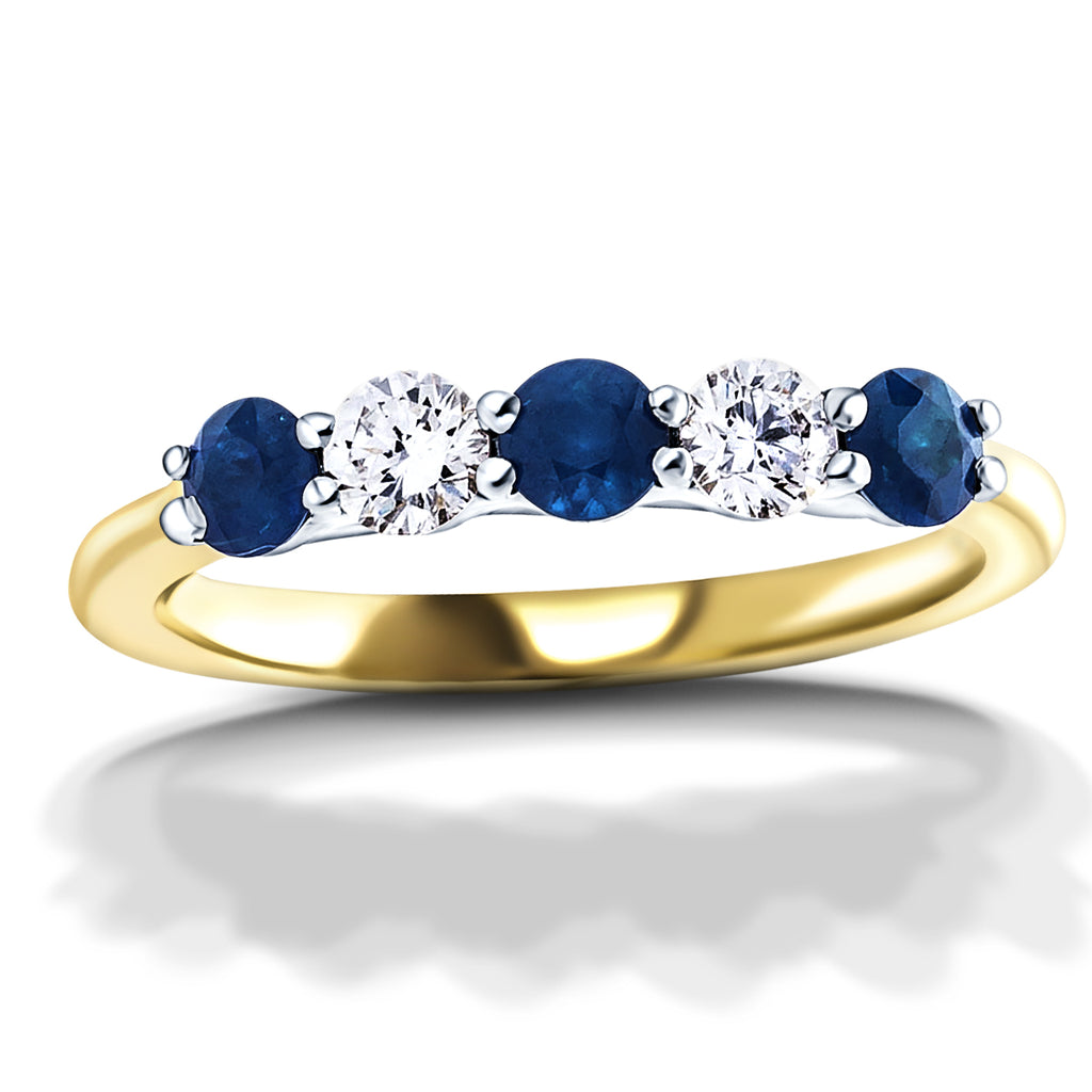 Anillo de cinco piedras con diamantes de 0,30 quilates y zafiro azul de 0,55 quilates en oro amarillo de 18 quilates